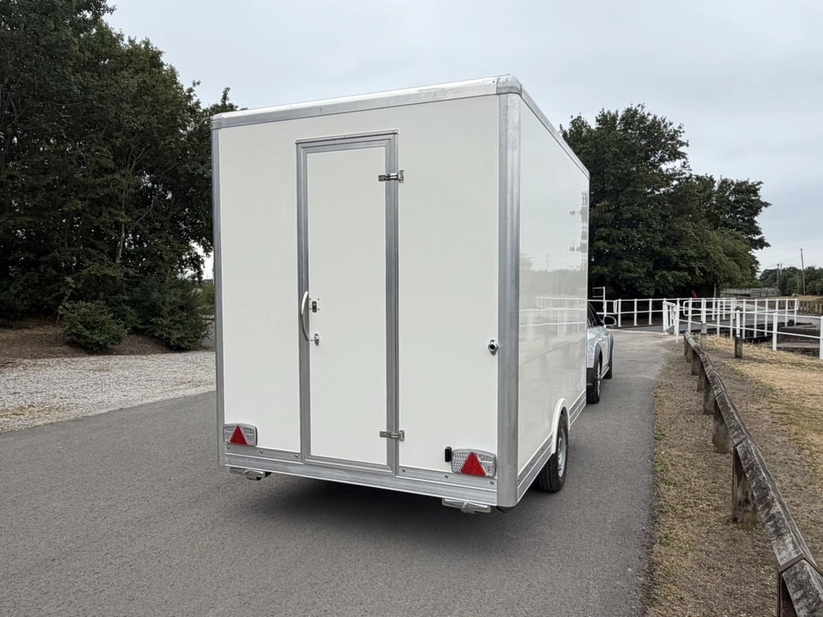Catering trailer hitched to a tow vehicle, ready to move